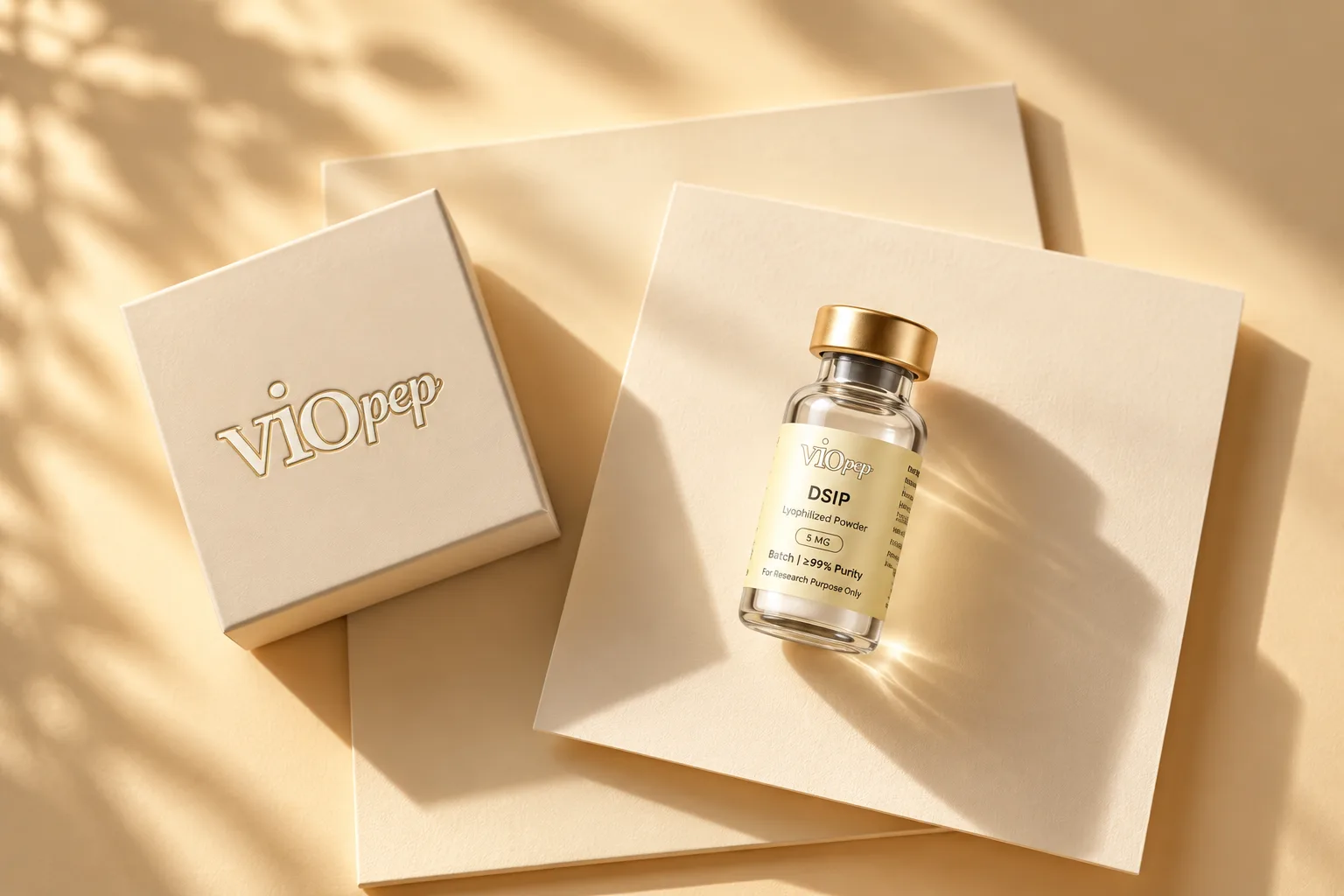 A labeled viopep vial on stacked cream cards beside an embossed viopep box, in dappled light