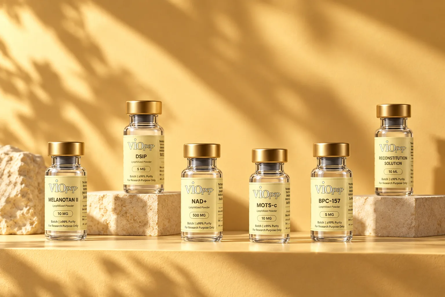 Six labeled viopep vials with gold caps standing in a row on a sunlit yellow shelf